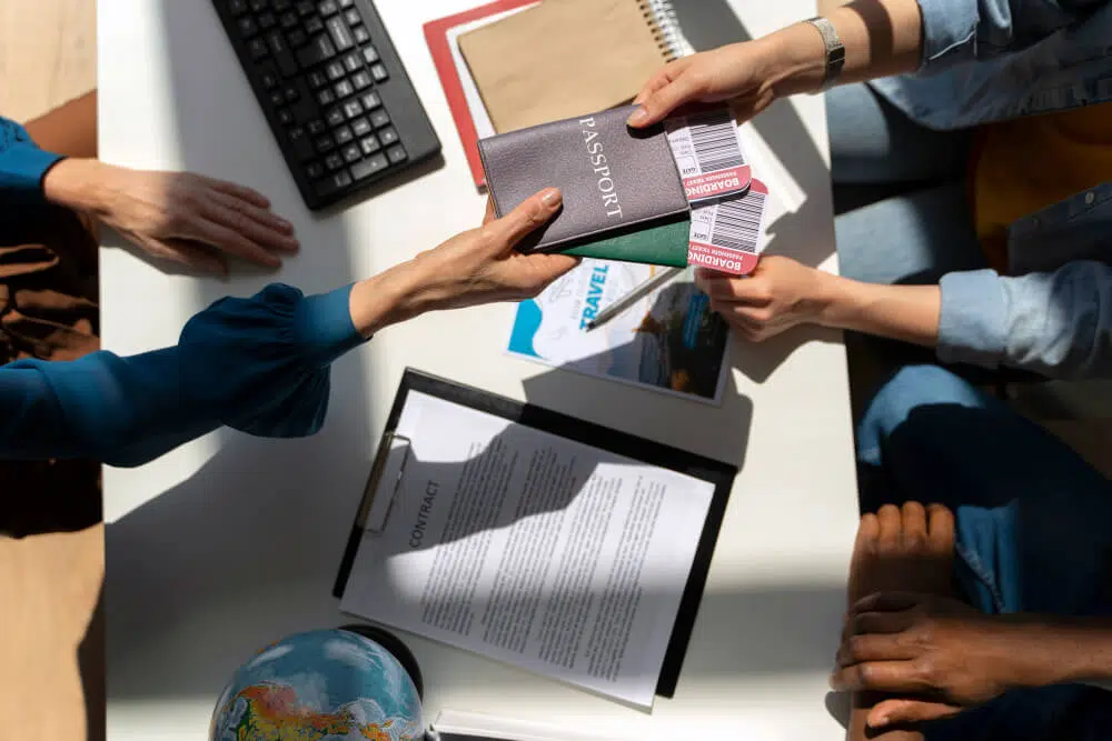 Skilled migration with passports and boarding passes being exchanged at a desk with travel documents.