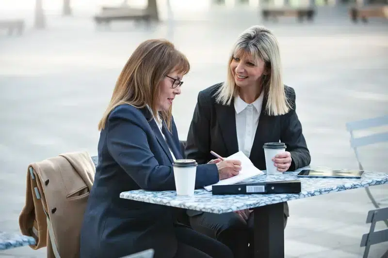 Pace Migration & Education Consultancy consultants discussing about parent visa applications during an outdoor meeting in Sydney.