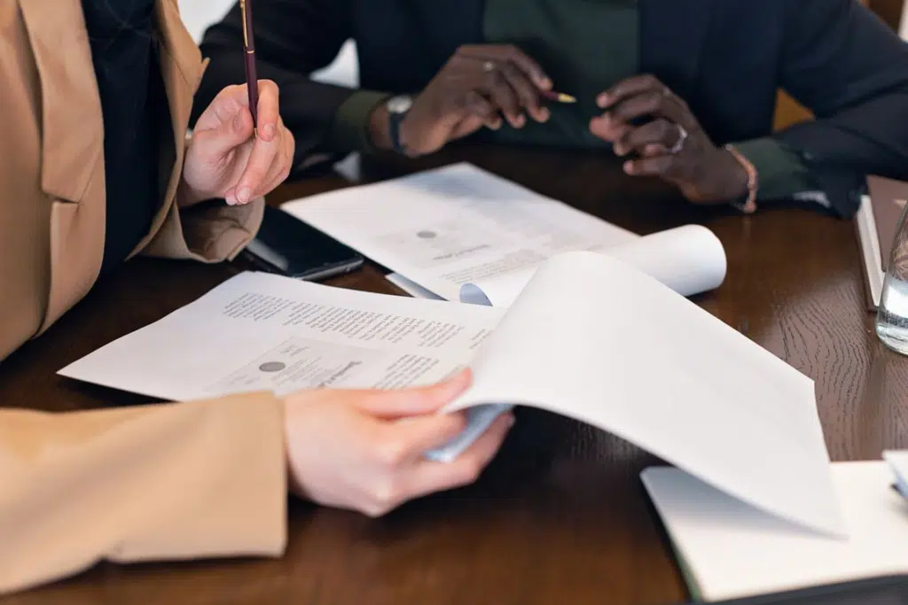Migration advisers checking application paperwork for Pace Migration’s Next 189 Invitation Round 2026 guide.